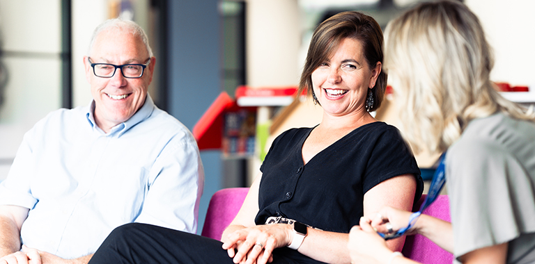 Colleagues smiling together in the iPipeline office